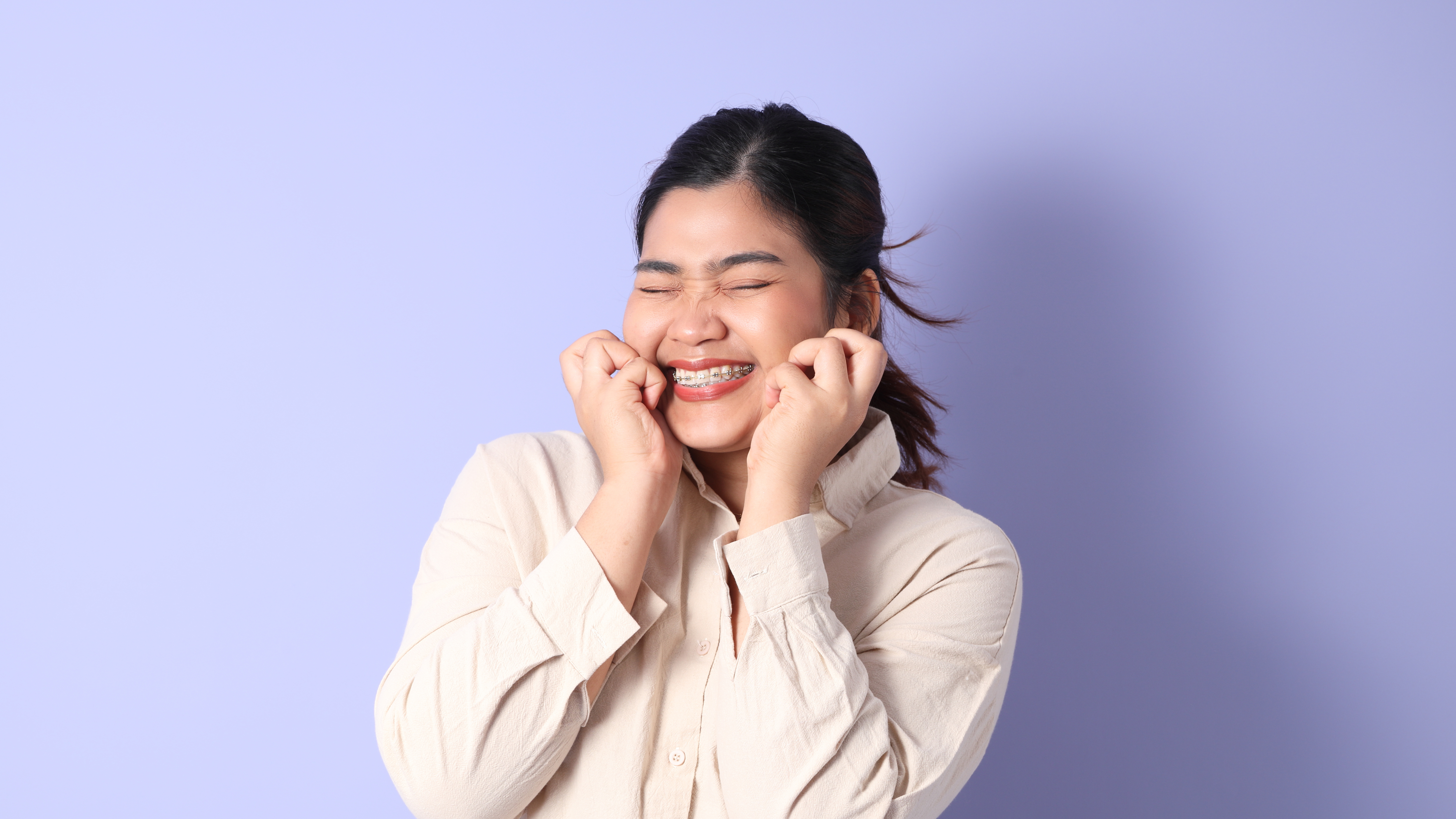 Young girl with braces with a nervous or shy expression.